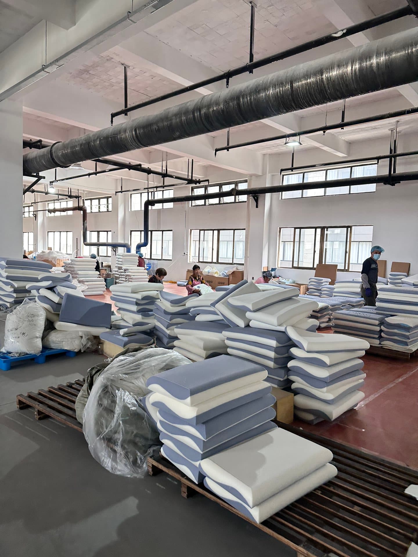 Pillow factory floor stacked high with finished pillow inventory